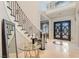 Elegant foyer with decorative staircase, marble floors, and a view of the front door at 5367 Secluded Brook Ct, Las Vegas, NV 89149