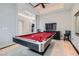 Spacious game room with pool table, bar, and view of foyer at 5367 Secluded Brook Ct, Las Vegas, NV 89149
