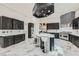 Beautiful kitchen with dark cabinetry, a large center island, stainless steel appliances, and a modern tile backsplash at 5367 Secluded Brook Ct, Las Vegas, NV 89149