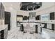 Spacious kitchen with dark cabinets, stainless steel appliances, large center island with white marble countertop and barstool seating at 5367 Secluded Brook Ct, Las Vegas, NV 89149