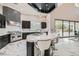 Stunning kitchen featuring dark cabinetry, a large island with bar seating, and stainless steel appliances at 5367 Secluded Brook Ct, Las Vegas, NV 89149