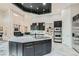 Open-concept kitchen featuring dark cabinets, stainless steel appliances, and a central island perfect for cooking and entertaining at 5367 Secluded Brook Ct, Las Vegas, NV 89149