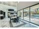Open concept living area showcasing a seamless transition to outdoor living with black framed sliding doors and outdoor patio views at 5367 Secluded Brook Ct, Las Vegas, NV 89149