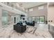 Expansive living room with marble floors, a wet bar, a view of the backyard, and soaring ceilings at 5367 Secluded Brook Ct, Las Vegas, NV 89149
