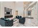 Spacious living room featuring soaring ceilings, marble floors, and luxurious furnishings at 5367 Secluded Brook Ct, Las Vegas, NV 89149