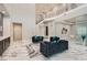 Bright and airy living room with soaring ceilings, staircase, and elegant decor at 5367 Secluded Brook Ct, Las Vegas, NV 89149