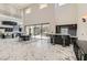 Open living and dining area with marble floors, a kitchen, and a view of the backyard at 5367 Secluded Brook Ct, Las Vegas, NV 89149