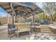 Outdoor kitchen featuring a built-in grill, counter space, bar seating, and a covered patio at 5367 Secluded Brook Ct, Las Vegas, NV 89149