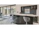 Modern wet bar features counter seating and wine fridge at 5367 Secluded Brook Ct, Las Vegas, NV 89149