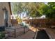 Inviting backyard retreat with mature trees, flagstone patio, and charming seating area, perfect for outdoor relaxation at 6623 Brick House Ave, Las Vegas, NV 89122
