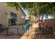 Private backyard featuring a patio, mature trees offering shade, and a well-maintained yard at 6623 Brick House Ave, Las Vegas, NV 89122