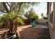 Spacious backyard featuring mature trees and a partially fenced-off section at 6623 Brick House Ave, Las Vegas, NV 89122