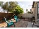 Backyard featuring mature trees, landscaping, and outdoor seating area at 6623 Brick House Ave, Las Vegas, NV 89122