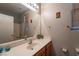 Bright bathroom with white sink and wood cabinets at 6623 Brick House Ave, Las Vegas, NV 89122