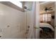 Clean bathroom with a shower-tub combo and a partial view into the main bedroom at 6623 Brick House Ave, Las Vegas, NV 89122