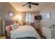 Comfortable bedroom showcasing a ceiling fan, a plush bed, and natural lighting at 6623 Brick House Ave, Las Vegas, NV 89122