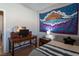 Well-lit bedroom featuring a decorative wall tapestry, desk, and a queen size bed at 6623 Brick House Ave, Las Vegas, NV 89122