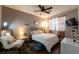 Comfortable bedroom showcasing a ceiling fan, a plush bed, and natural lighting at 6623 Brick House Ave, Las Vegas, NV 89122