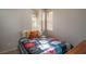 Cozy bedroom with two windows, a colorful bedspread, and a charming decor at 6623 Brick House Ave, Las Vegas, NV 89122