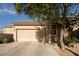 Charming single-story home with a two-car garage, desert landscaping, and a welcoming entryway at 6623 Brick House Ave, Las Vegas, NV 89122