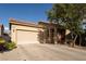 Charming single-story home with a two-car garage, desert landscaping, and a welcoming entryway at 6623 Brick House Ave, Las Vegas, NV 89122