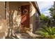Cozy front porch featuring a decorative wreath, garden and 'happy hour' welcome mat at 6623 Brick House Ave, Las Vegas, NV 89122