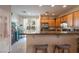 Eat in kitchen featuring stainless steel appliances, granite counters, wooden cabinetry and breakfast bar at 6623 Brick House Ave, Las Vegas, NV 89122