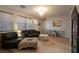 Inviting living room featuring tile floors, many windows, and modern light fixtures at 6623 Brick House Ave, Las Vegas, NV 89122