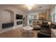 Open concept living space with tile flooring, modern lighting, and seamless flow into the kitchen area at 6623 Brick House Ave, Las Vegas, NV 89122