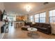 Open concept living space with tile flooring, modern lighting, and seamless flow into the kitchen area at 6623 Brick House Ave, Las Vegas, NV 89122