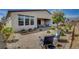 Spacious backyard with desert landscaping and a covered patio area at 6830 Compass St, North Las Vegas, NV 89084