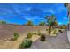 Large backyard featuring desert landscaping and block wall surround at 6830 Compass St, North Las Vegas, NV 89084