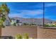 View of desert landscape and mountains beyond brick backyard wall at 6830 Compass St, North Las Vegas, NV 89084