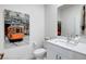 Elegant half-bathroom with modern fixtures, white vanity, and vibrant wall art at 6830 Compass St, North Las Vegas, NV 89084