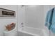 Clean white bathroom with modern fixtures and tub/shower combo featuring a starfish art piece at 6830 Compass St, North Las Vegas, NV 89084
