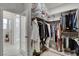 Walk-in closet with mirrored door into the adjacent bathroom at 6830 Compass St, North Las Vegas, NV 89084