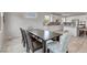 Open dining room with a view of the kitchen, features a stylish table and chairs at 6830 Compass St, North Las Vegas, NV 89084