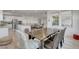 Open-concept dining room with a wood table, seamlessly connected to the modern kitchen and living spaces at 6830 Compass St, North Las Vegas, NV 89084