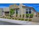 Modern house exterior with rock mulch and drought tolerant bushes in front yard at 6830 Compass St, North Las Vegas, NV 89084