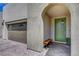 Home's stylish covered entryway features a unique arched alcove and modern front door at 6830 Compass St, North Las Vegas, NV 89084