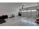 Spacious garage with an epoxy floor offering ample parking and storage solutions at 6830 Compass St, North Las Vegas, NV 89084
