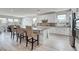A modern kitchen featuring an island with bar seating, stainless steel appliances, and bright lighting at 6830 Compass St, North Las Vegas, NV 89084