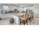 A bright kitchen with an island and bar stools, stainless appliances, and tiled backsplash at 6830 Compass St, North Las Vegas, NV 89084