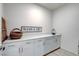 Functional laundry room with ample counter space and stylish storage cabinets at 6830 Compass St, North Las Vegas, NV 89084