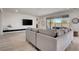 Open concept living room with modern furniture, wall-mounted TV, and patio access at 6830 Compass St, North Las Vegas, NV 89084