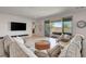 Comfortable living room with sliding doors to the back patio and neutral decor at 6830 Compass St, North Las Vegas, NV 89084