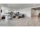 Open concept living space with light tile floors, a kitchen, and modern decor at 6830 Compass St, North Las Vegas, NV 89084