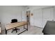 Home office area featuring a modern desk and access to a half bath and closet at 6830 Compass St, North Las Vegas, NV 89084