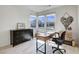 Bright office space with a modern desk and three large windows at 6830 Compass St, North Las Vegas, NV 89084
