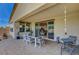 Outdoor patio area with covered seating and a sliding glass door at 6830 Compass St, North Las Vegas, NV 89084